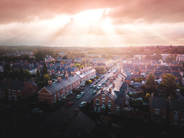 istock Sun bursting through clouds over traditional UK British houses 1354710817