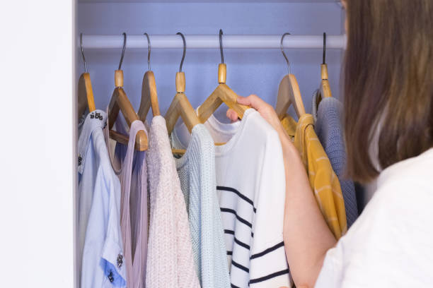 istock Woman at wardrobe with clothes 1354712755