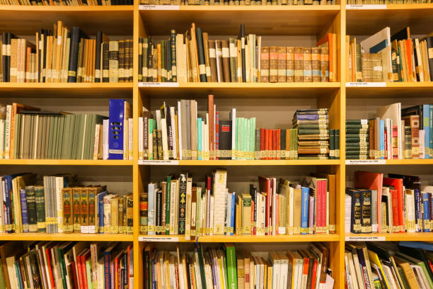 istock Colorfully mixed bookshelf as a bookcase with old and new books in different sizes 1354713283
