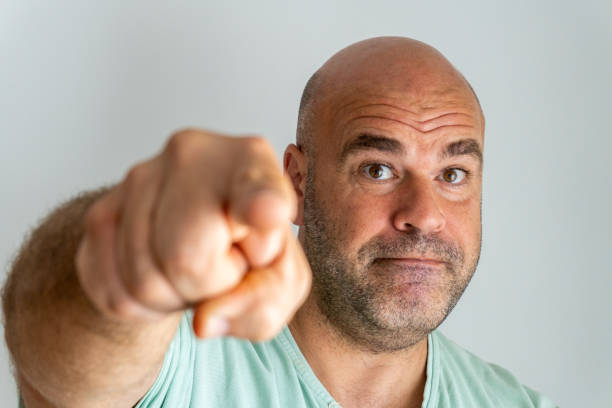 istock caucasian man face, gesturing and accusing with the index finger 1354714371