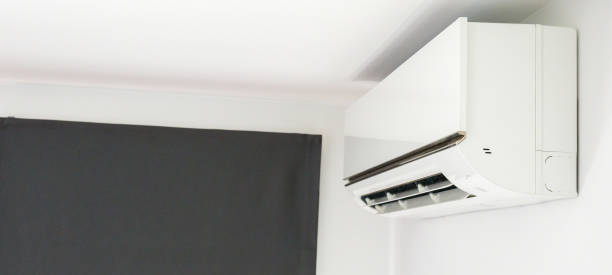 istock Air conditioner on white wall room interior background 1354714443