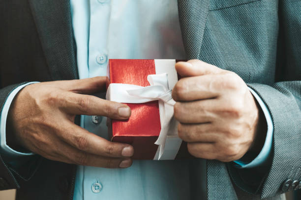 istock Businessman giving Gift Box 1354714570