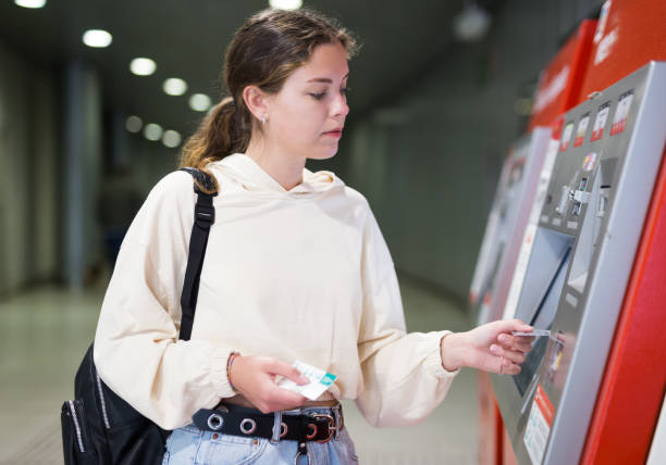 istock Woman buying a ticket to the subway train 1354720189