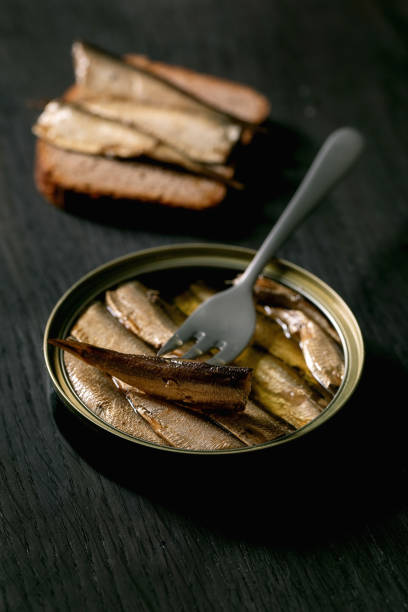 istock Open can with canned sprats in oil 1354721382