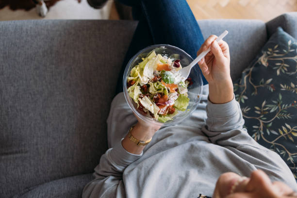 istock Unrecognizable Woman Eating a Salad at Home 1354721707