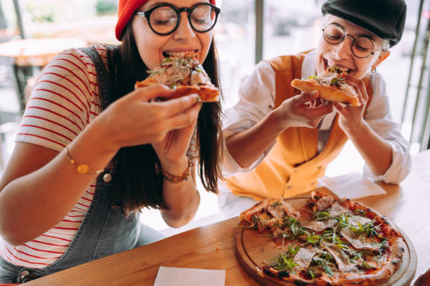 istock Lesbian couple eating the pizza 1354722642