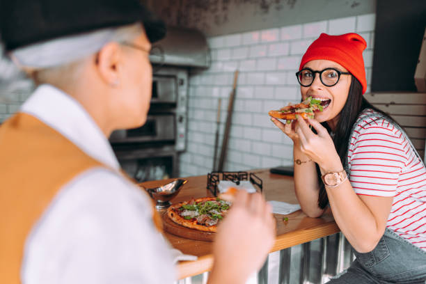 istock Lesbian couple eating the pizza 1354722686
