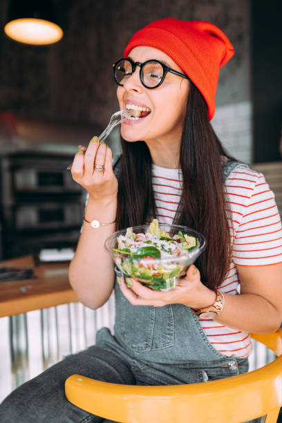 istock The girl is eating a salad in a restaurant 1354722821