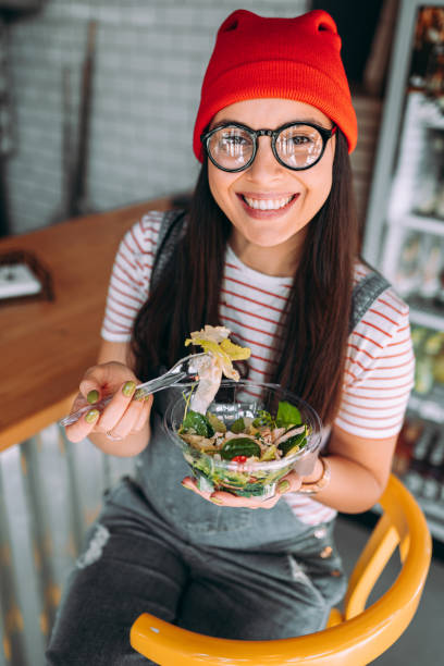 istock Owner eats salad in his store 1354723370