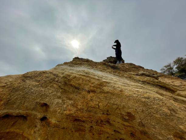 istock Man on top of a rock 1354724566