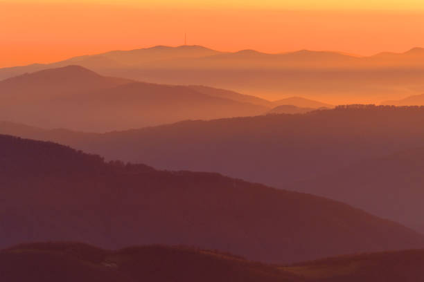 istock Abstract orange sunset over the evening mountains 1354724729
