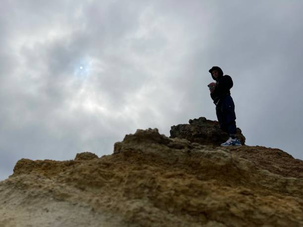 istock Man on top of a rock 1354724832