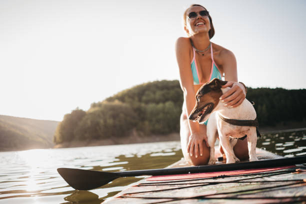 istock Paddleboarding Woman With Dog 1354725127