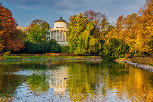 The Saxon Garden (Ogrod Saski) in Warsaw, Poland. Public park in the city center, scenic autumn landscape with lake and Water Tower.