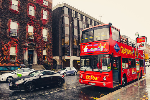 Twickenham, UK. 2 December 2023. Buses on Twickenham King Street with shops and people.