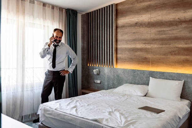 istock Mature businessman is calling to discuss about the work by the window 1354729968