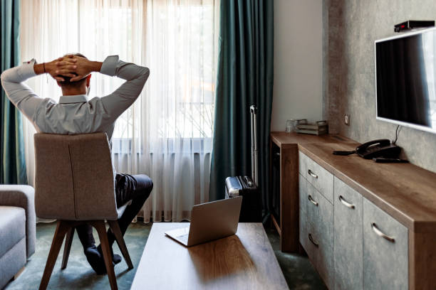 istock Businessman relaxing in hotel room. 1354730008