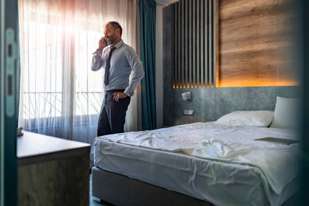 istock Attractive man speaking on telephone with boss 1354730018