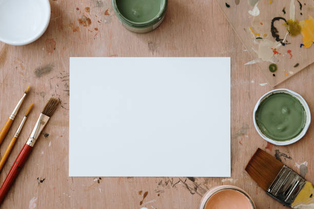istock A blank white paper on a paint splashed wooden board 1354731418