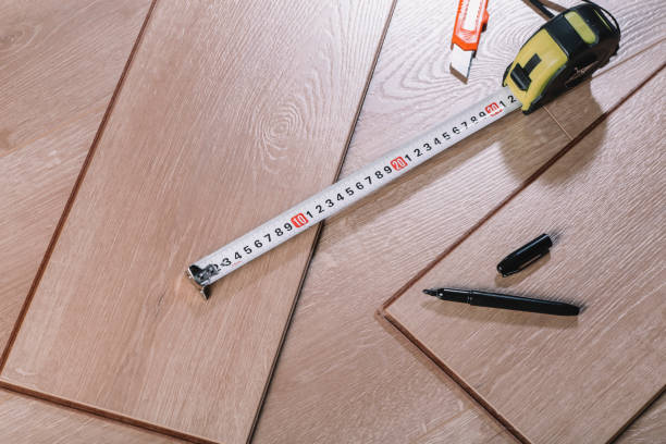 istock Installing laminate flooring in a room or office. Wooden parquet boards and tools. Construction and decorative works for the finishing of housing 1354731817