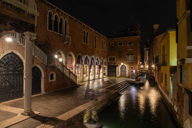 a canal somewhere in san polo district in venice at night - market rialto bridge venice italy italy imagens e fotografias de stock