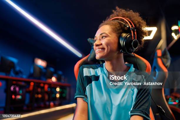 Female Gamer Relaxes After Tournament In Cyber Club Stock Photo - Download Image Now