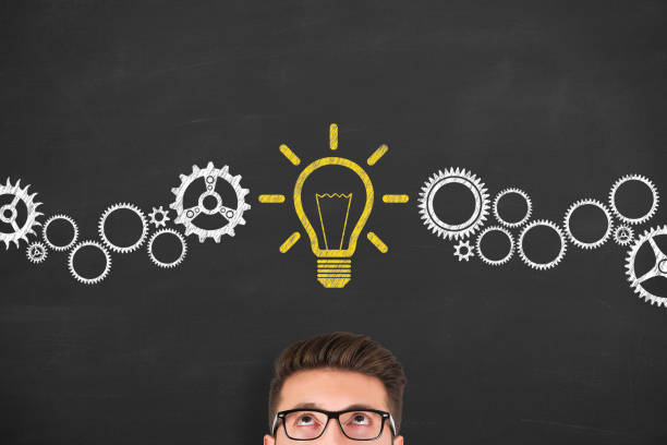 istock Creative idea concepts with light bulbs over human head on a chalkboard background 1354736487