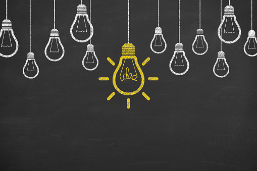 New idea concepts with light bulbs on a chalkboard background