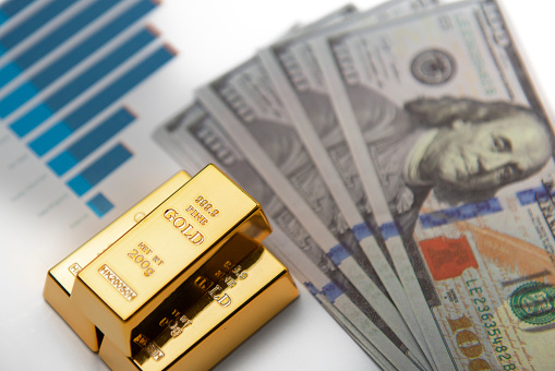 The American currency is the dollar. Statistics data showing hundred dollar bills, gold bullion and data analysis