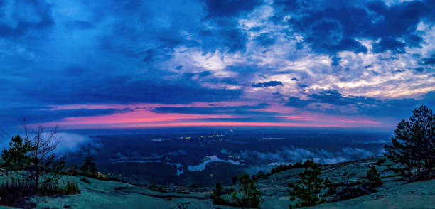 Wide shot of early morning glow on mostly cloudy day from mountain top stock photo