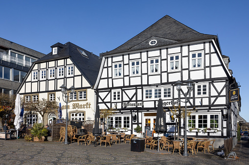 Brilon, Germany - November 12 2021: Marketplace downtown medieval German city Brilon with facade of medieval restaurant