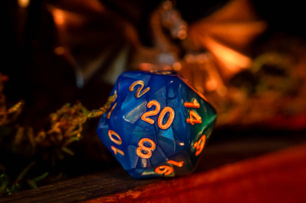 istock Close-up image of a blue d20 in warm light 1354744116