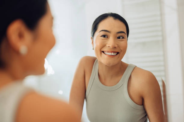 istock Morning Routine: Beautiful Woman Analyzing Her Face Skin in the Mirror 1354745012