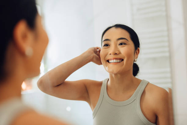 istock Morning Routine: Beautiful Woman Analyzing Her Face Skin in the Mirror 1354745017