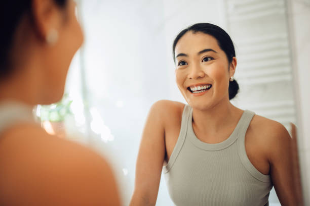 istock Morning Routine: Happy Asian Woman Looking Herself in the Mirror 1354745018