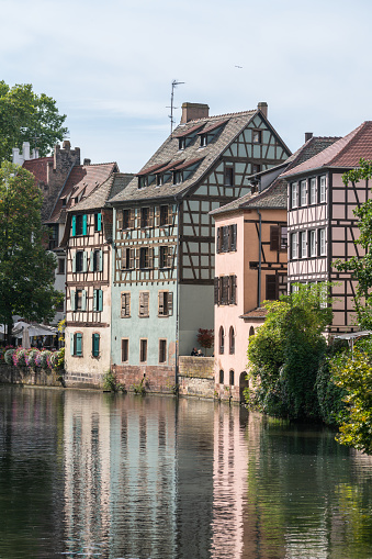 Colorful half-timbered medieval buildings on the bank of the river Ill on a late September evening