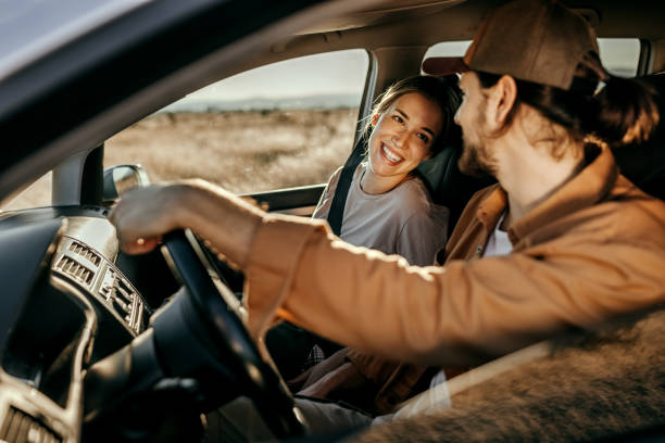 istock Couple having fun on car road trip 1354752730