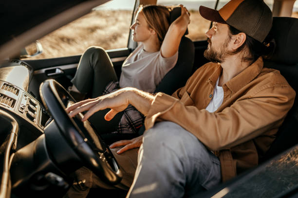 istock Couple admiring view from car on a road trip 1354752803