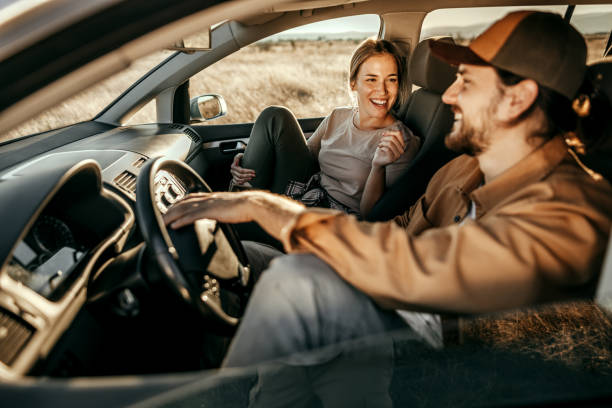 istock Couple having fun on car road trip 1354752822