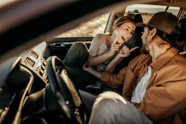 istock Couple having fun on car road trip 1354752858