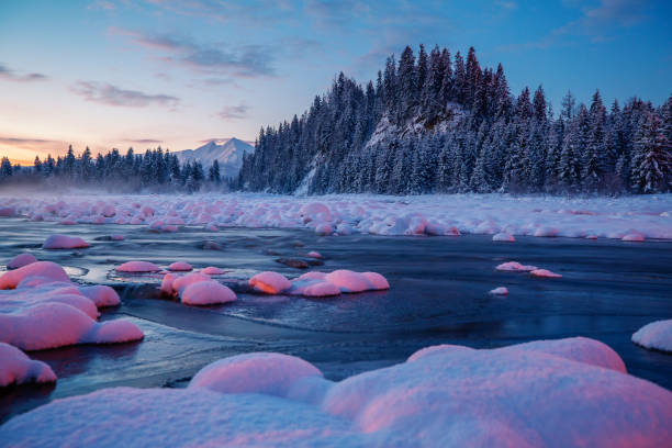 Beautiful winter landscape with mountains and lake. Trees covered with snow. Scenic winter background.
