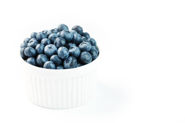 istock Blueberries in a white Cup on a white background. Isolate, free space 1354753262