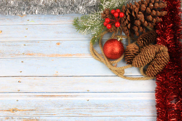 christmas background with red baubles, pinecones and tinsel