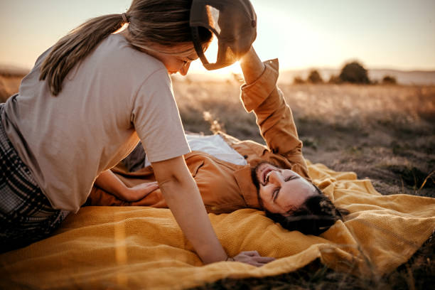 istock Loving couple relaxing on field 1354754134