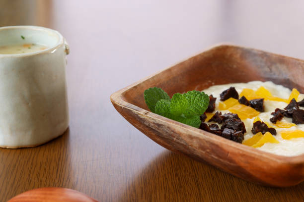 istock Yogurt with soup in the cup on the wooden table. 1354754383