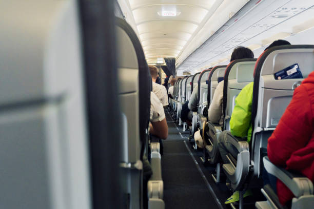 istock Airplane with passengers in seats waiting for take off. 1354755182