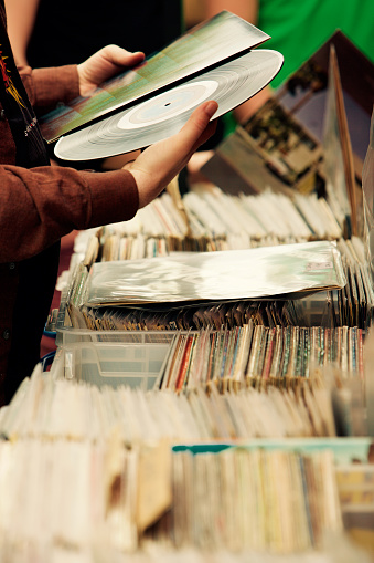 Close up on hands choosing LP records. High quality photo