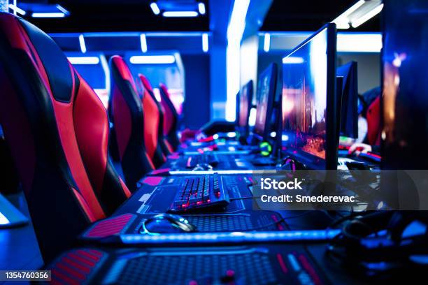 Game Room Interior With Modern Ambient Lights And Powerful Super Computers Consoles Keyboards For Playing Video Games Entertaining Industry Stock Photo - Download Image Now