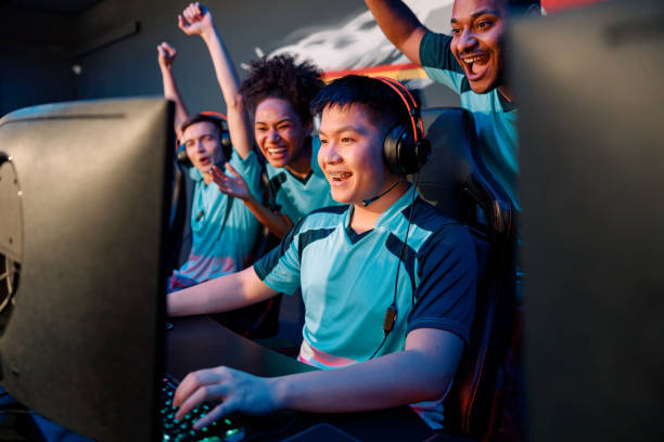 team of professional cybersport gamers celebrating success in gaming club - esport audience bildbanksfoton och bilder