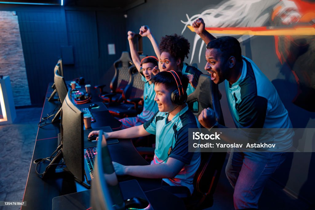 Young gamers playing online video game in cyber club - Royaltyfri Gamer Bildbanksbilder